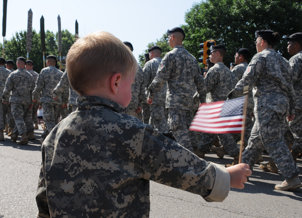 Memorial day. A female soldier in uniform salutes against the