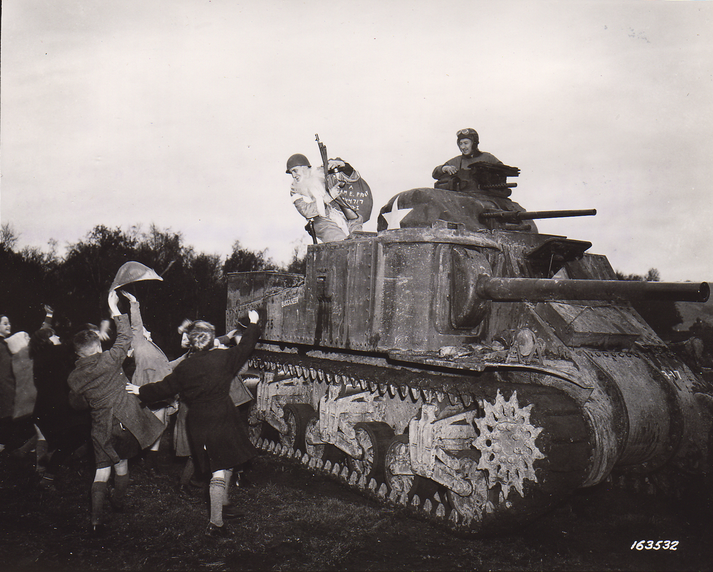 Sgt. Hiram Prouty of US 175th Infantry Regiment dressed as Santa Claus arriving on a M3 medium tank in Perham Down, England, 12/5/1942