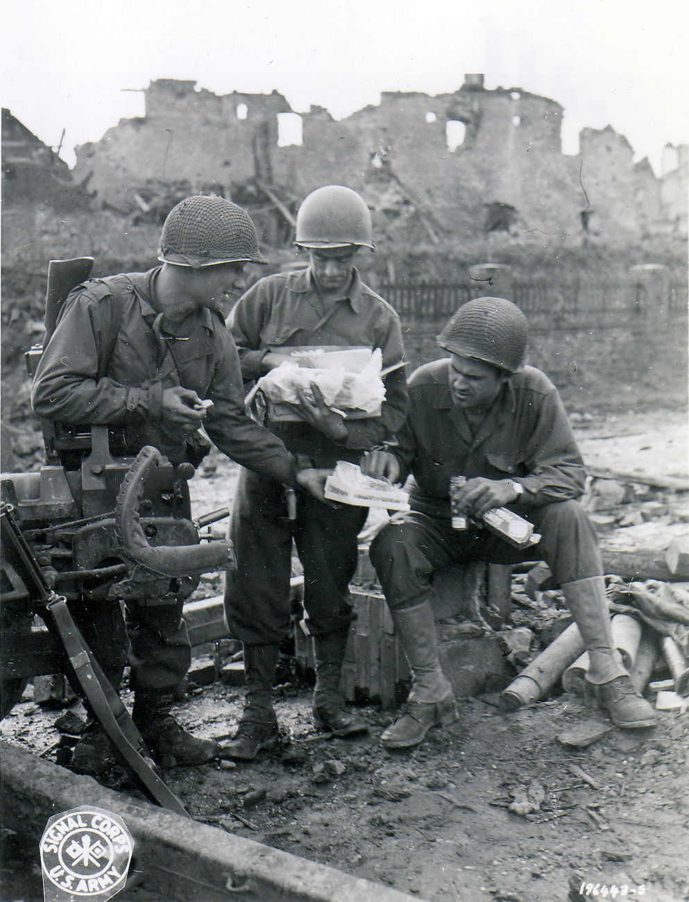 US Army soldiers sharing care package sent by one of their wives for Christmas, somewhere in Europe, 11/18/1944