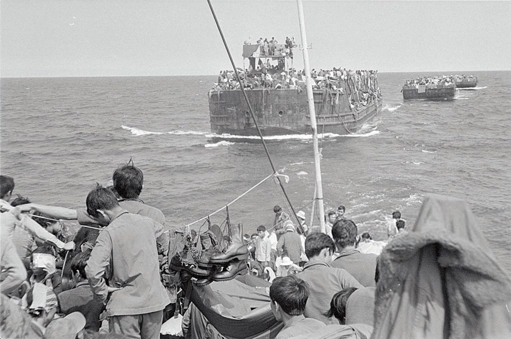 Vietnamese Refugees Being Towed Behind a Larger ShipApril 03, 1975