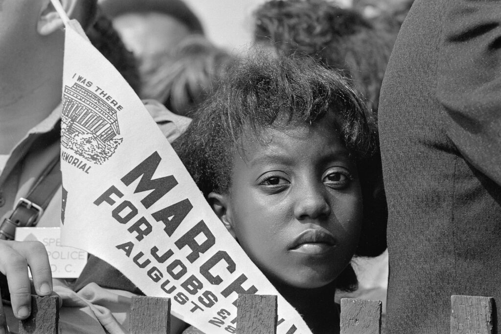 A_Young_Woman_Holds_a_Banner_at_the_Civil_Rights_March_on_Washington,_D.C.,_on_August_28,_1963