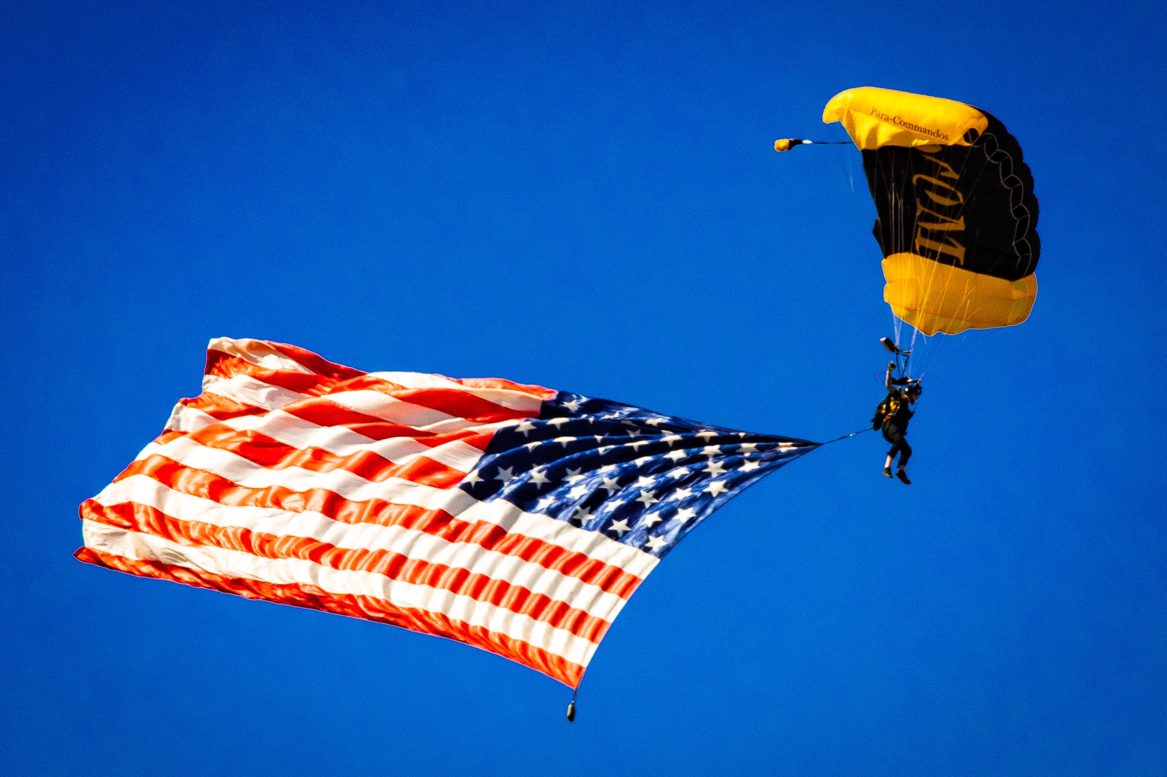 A member of the Golden Knight team parachutes down to the ground