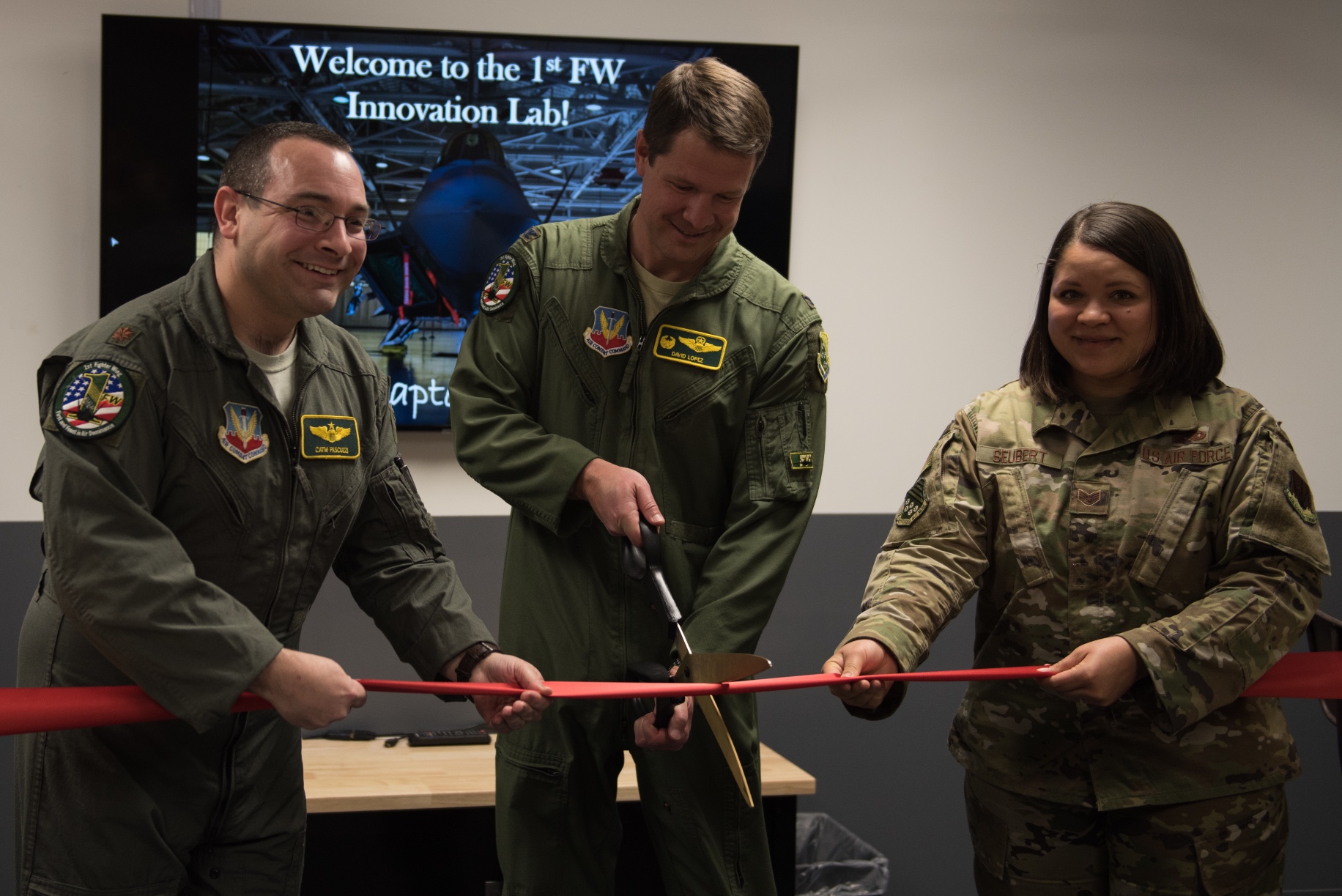 A ribbon is cut at the opening ceremony of the innovation lab at Joint Base Langley-Eustis, Virginia