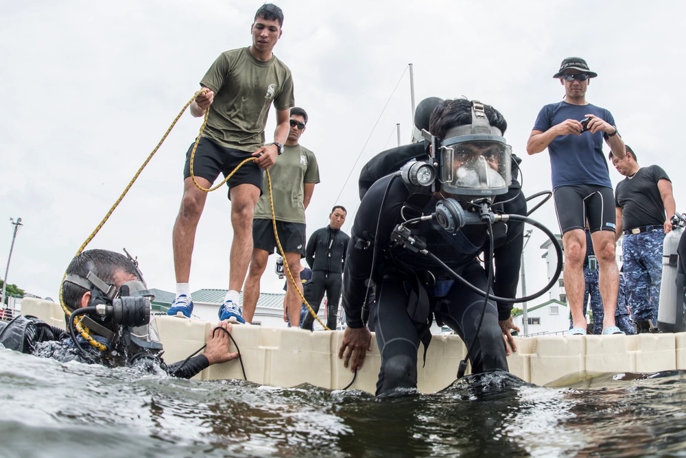 An Indian Explosive Ordnance Disposal (EOD) technician enters the water during a training dive as part of exercise Malabar 2016.