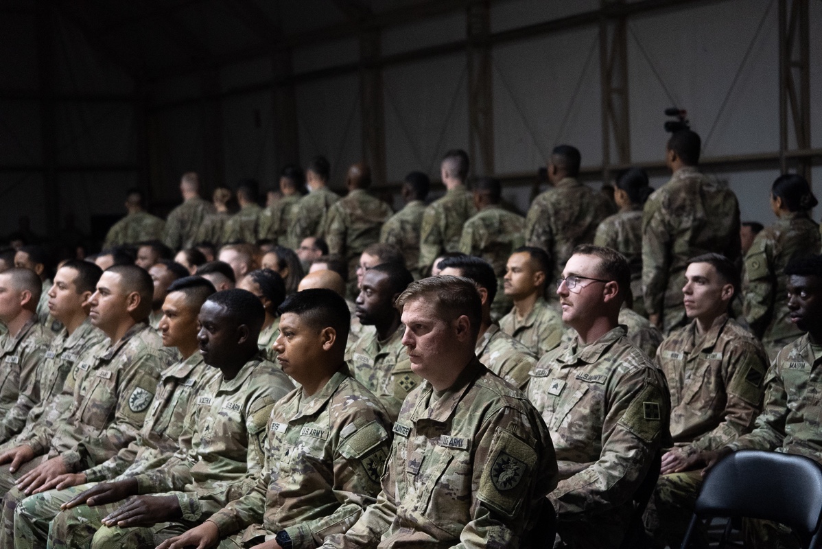 The last row of U.S. Army Soldiers makes their way to the stage to walk through the Noncommissioned Officer (NCO) arch