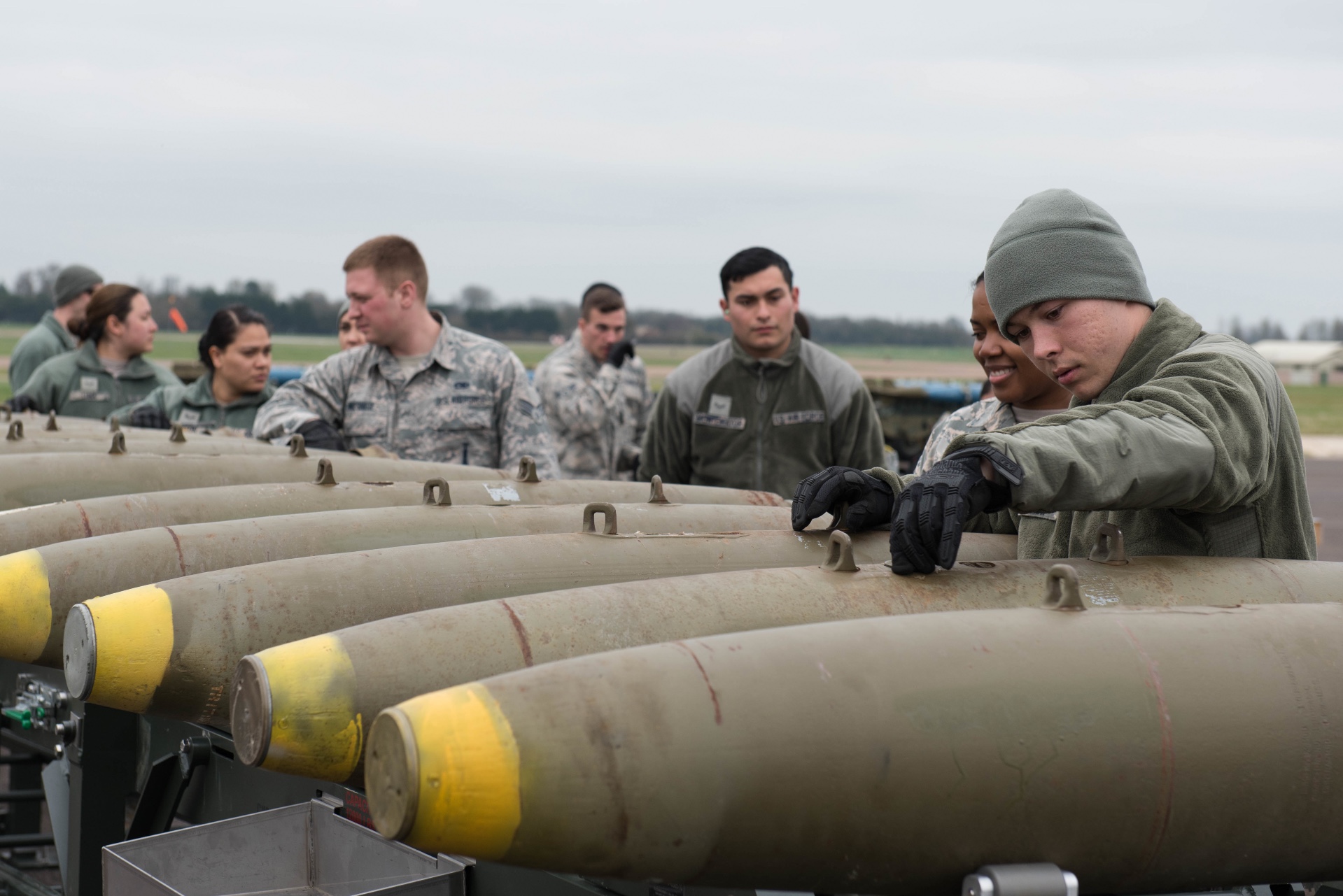 Airmen assigned to the 2nd Munitions Squadron assembly munitions, deployed from Barksdale Air Force Base, La., work on a Guided Bomb Unit - 38 at RAF Fairford, England