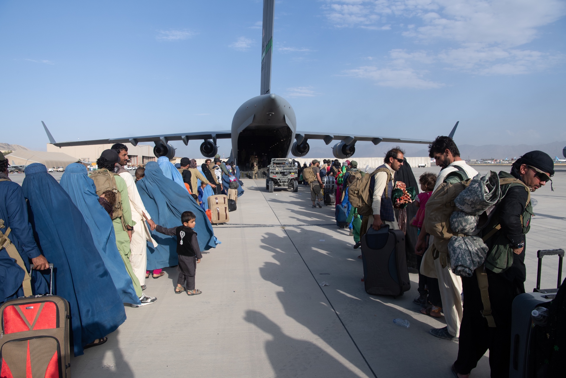 U.S. Air Force loadmasters and pilots assigned to the 816th Expeditionary Airlift Squadron, load passengers aboard a U.S. Air Force C-17 Globemaster III in support of the Afghanistan evacuation at Hamid Karzai International Airport