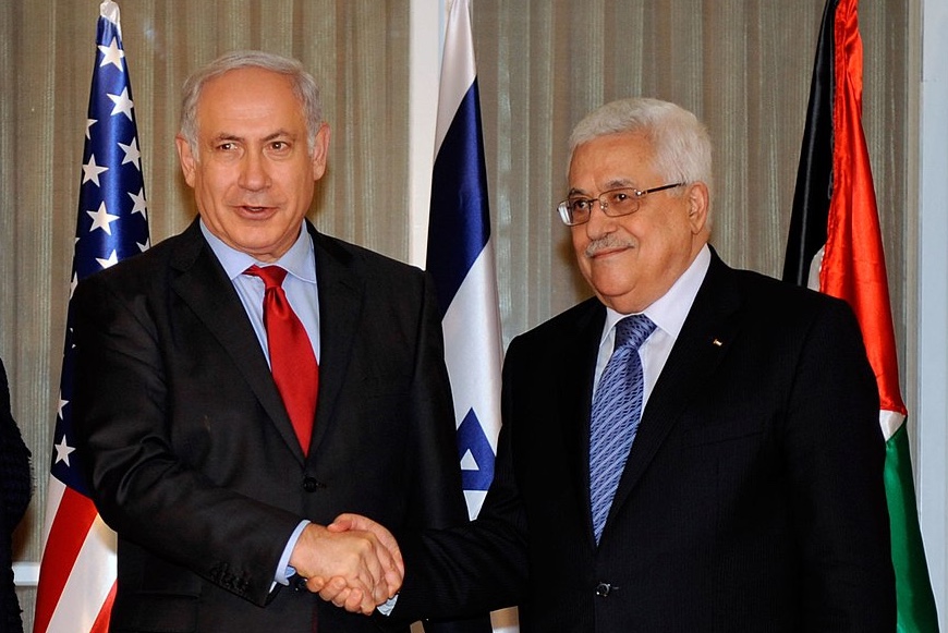 Israeli Prime Minister Benjamin Netanyahu (center) shakes hands with Palestinian President Mahmoud Abbas (right) as U.S. Secretary of State Hillary Rodham Clinton (left) looks on at the Prime Minister's Residence in Jerusalem, Israel, on September 15, 2010