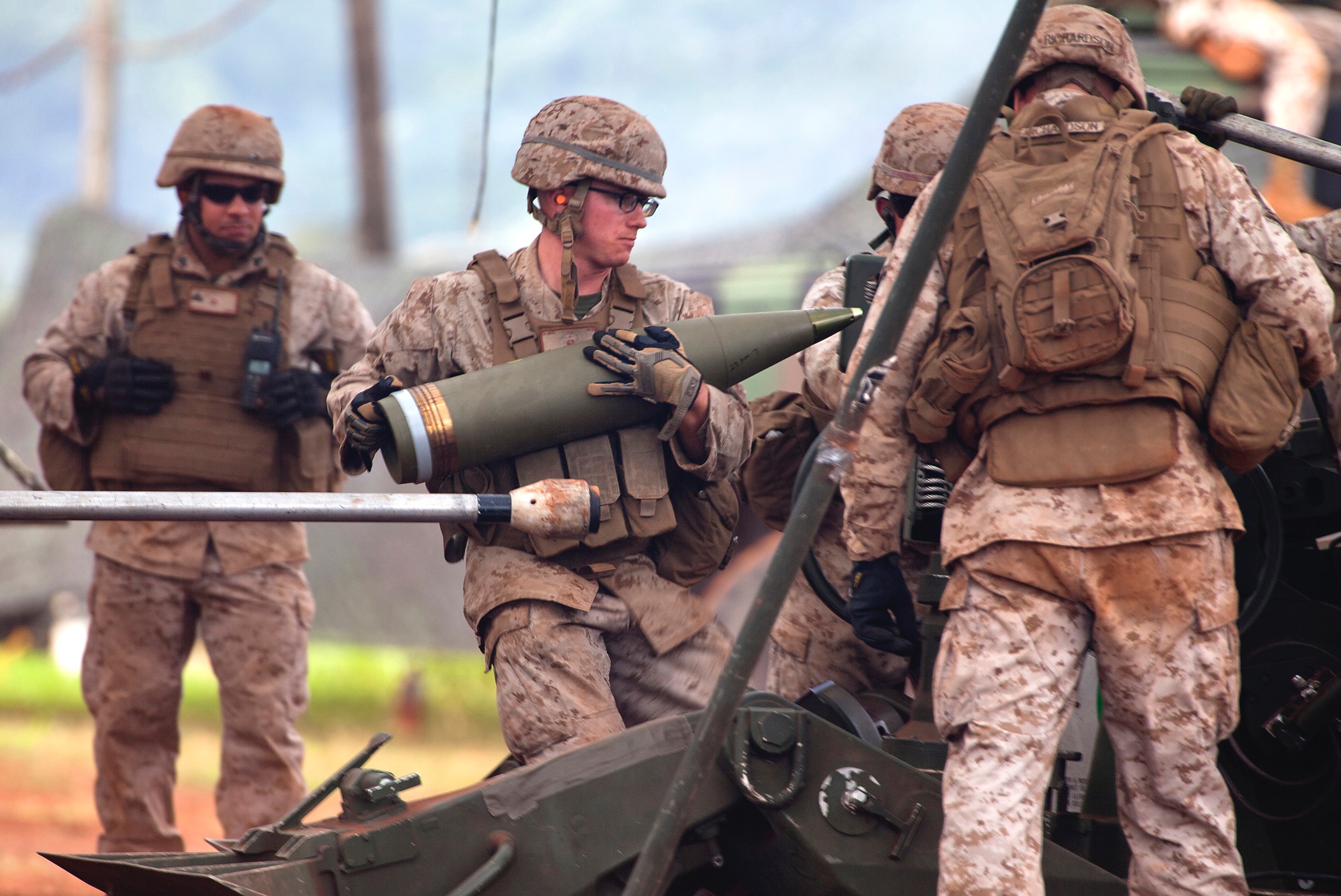 Lance Cpl. Jake Balcom, a cannoneer with Alpha Battery, 1st Battalion, 12th Marine Regiment, prepares to load a 155 mm artillery shell into an M777 howitzer in response to receiving a fire mission during a tree day training exercise at Schofield Barracks, June 11, 2013