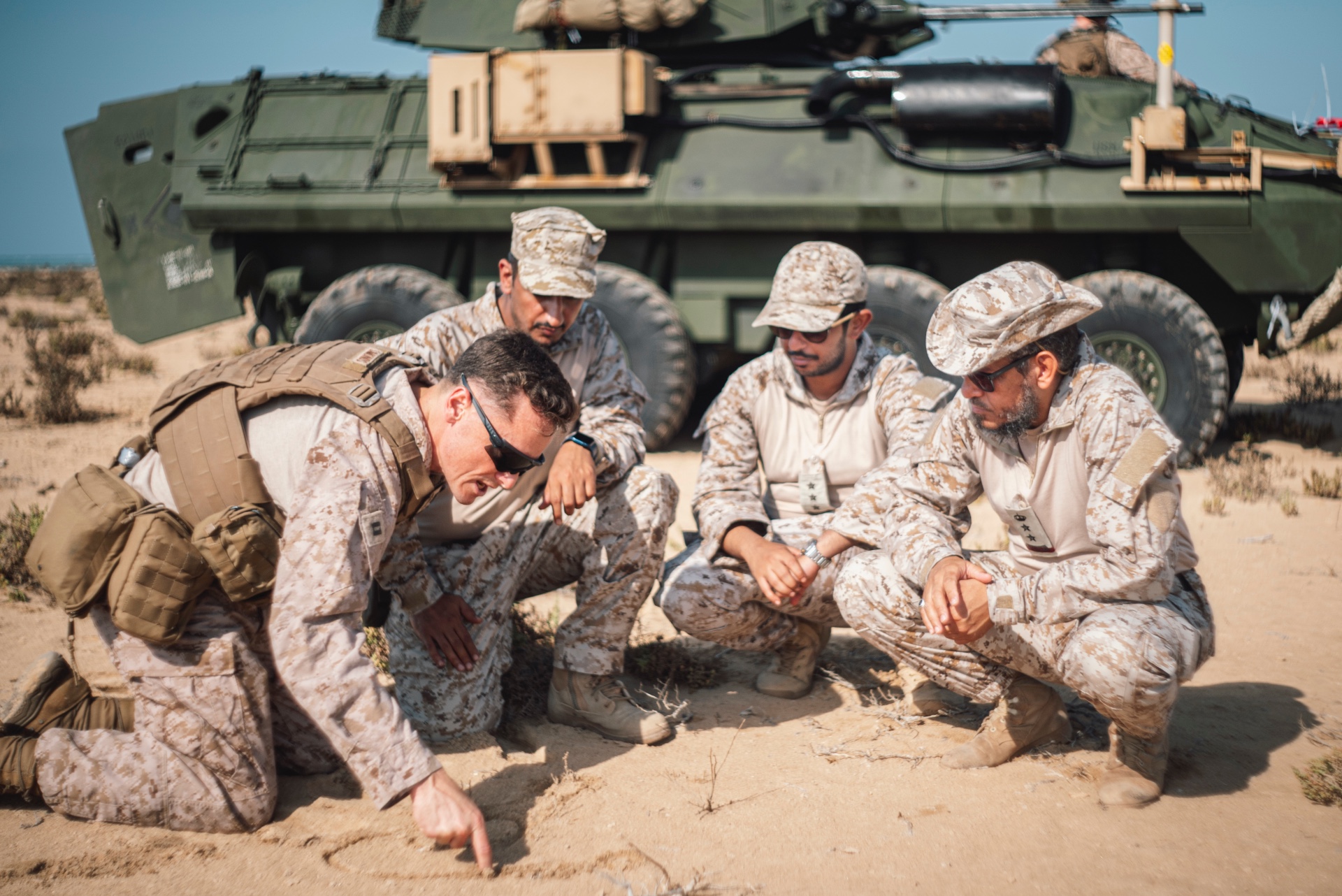the 11th Marine Expeditionary Unit, briefs the scheme of maneuver for an integrated exercise with members of the Royal Saudi Naval Forces during exercise Indigo Defender 21 at Jazirat al Ghurab Island, Saudi Arabia