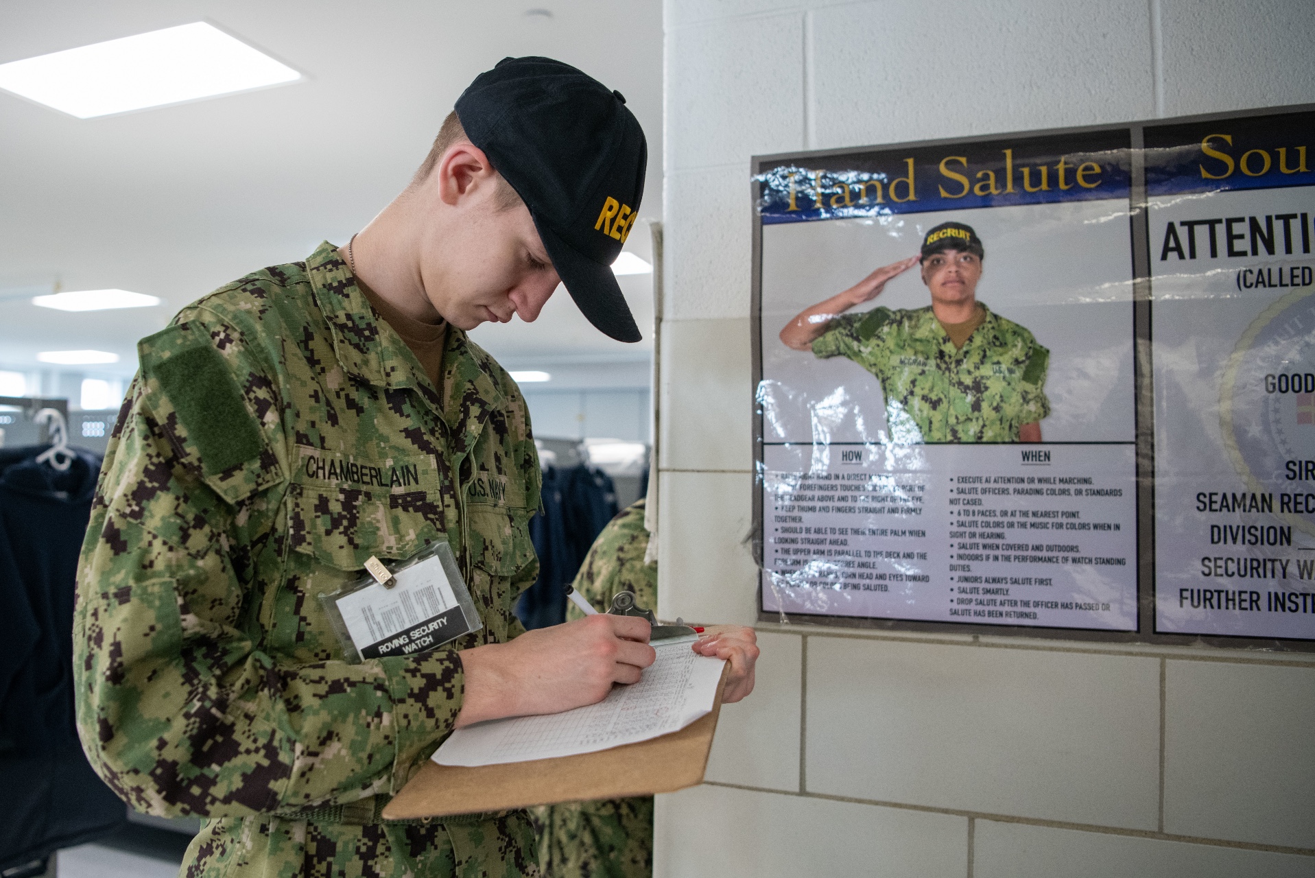 Recruits read their Recruit Training Guide for Basic Military Training in a compartment of the USS Hopper at Recruit Training Command, Great Lakes, Illinois.
