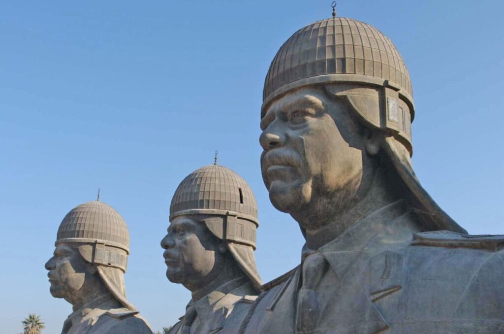 Three statues of Saddam Hussein